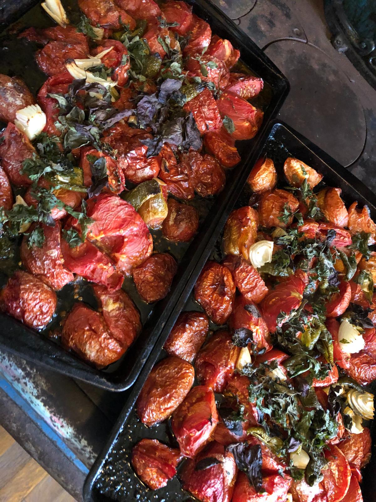 Pans of roasted tomatoes and vegetables for sauce